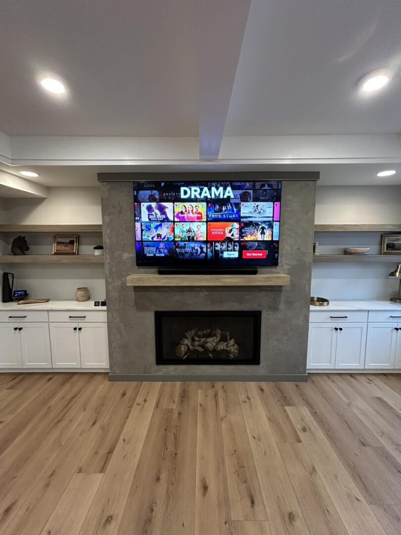 Living room with TV above fireplace.