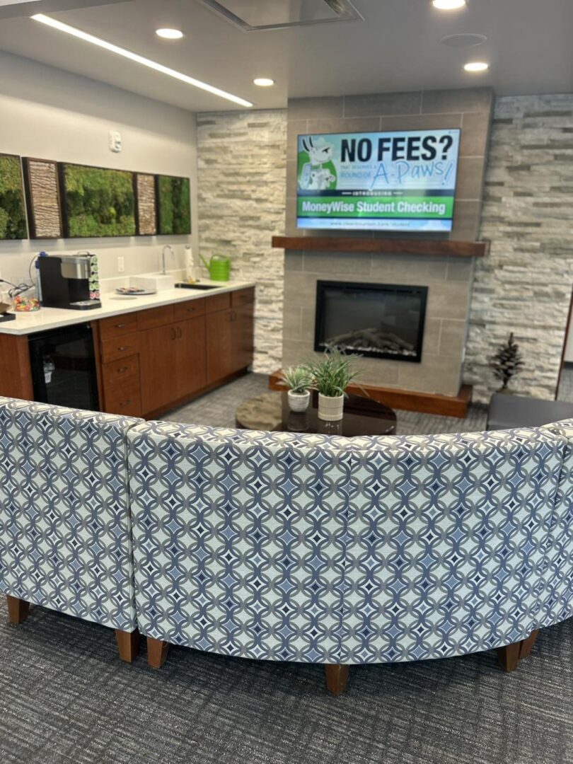 Modern lounge with fireplace and patterned sofa.