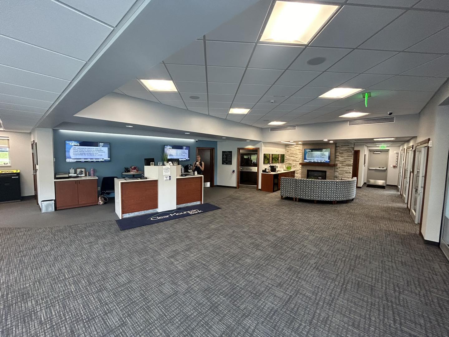Spacious modern office lobby with desks.