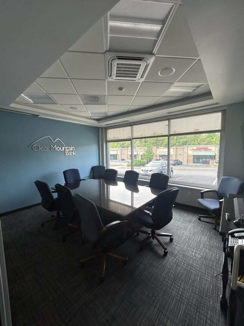 Conference room with large table and chairs.