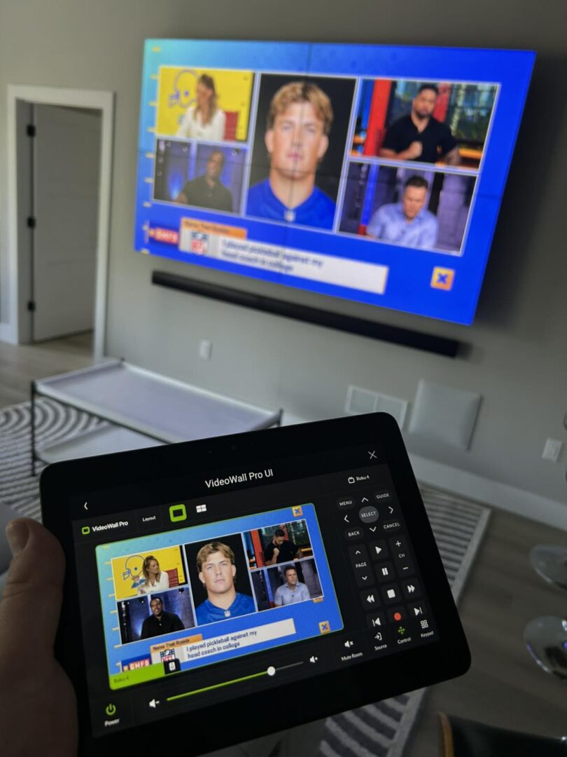 Tablet controlling large TV screen display.