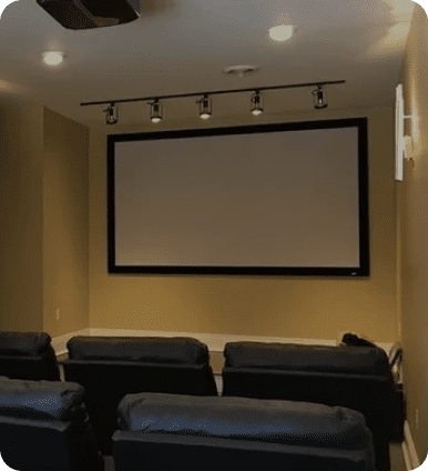 Home theater with screen and seating.