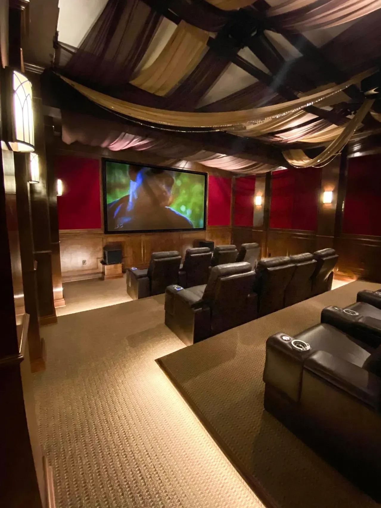 Home theater with reclining chairs and screen.
