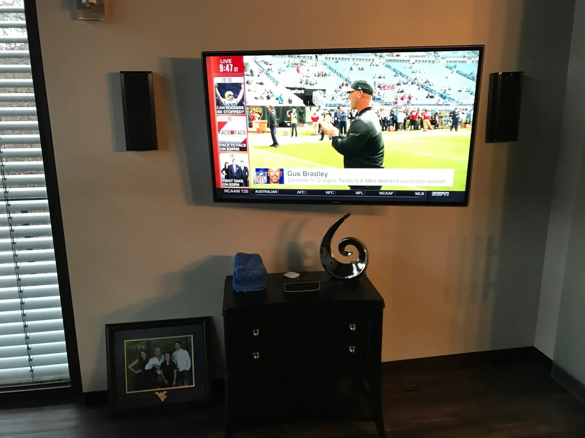 Television displaying sports channel in living room.