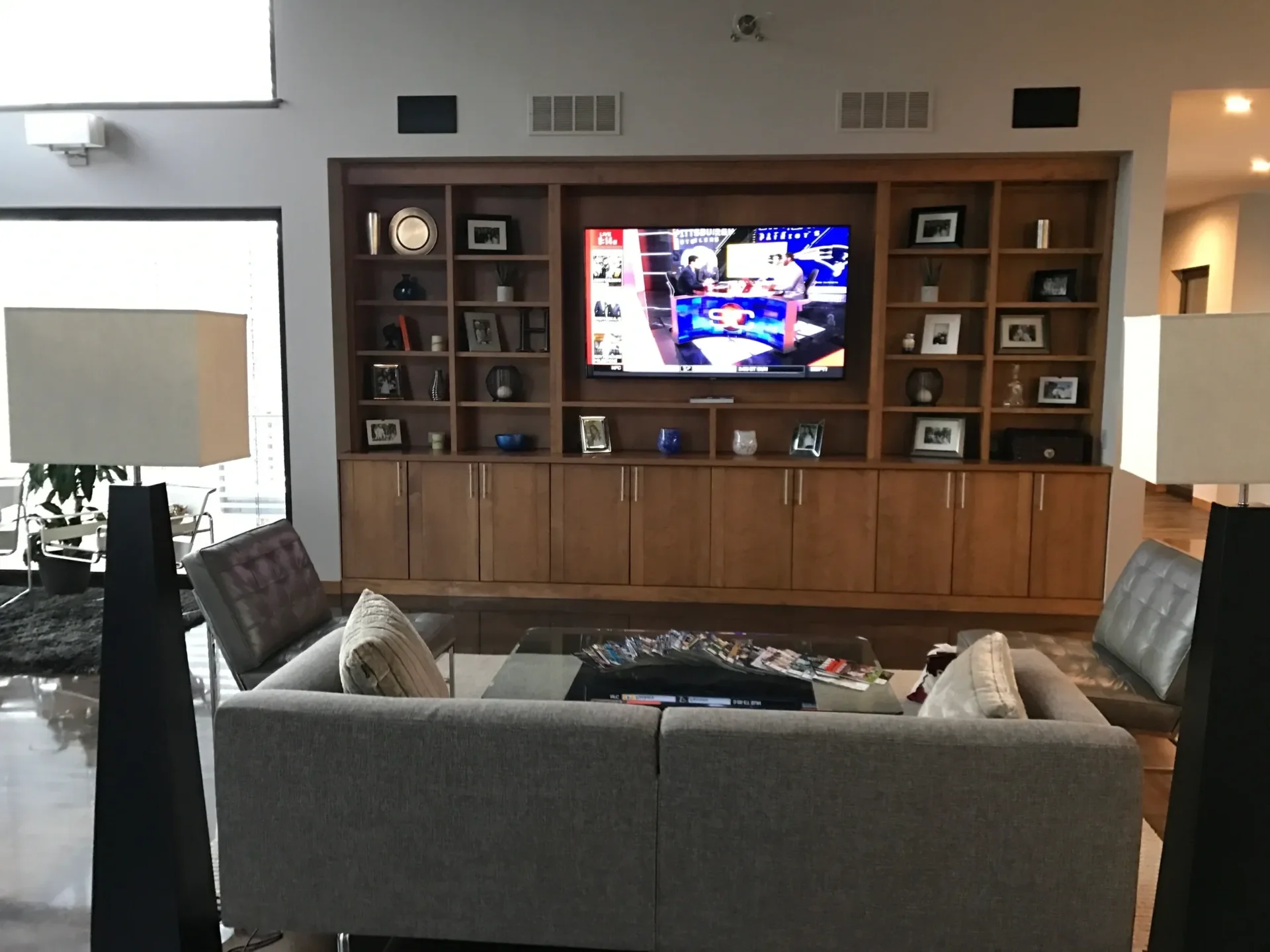 Living room with TV and bookshelves.