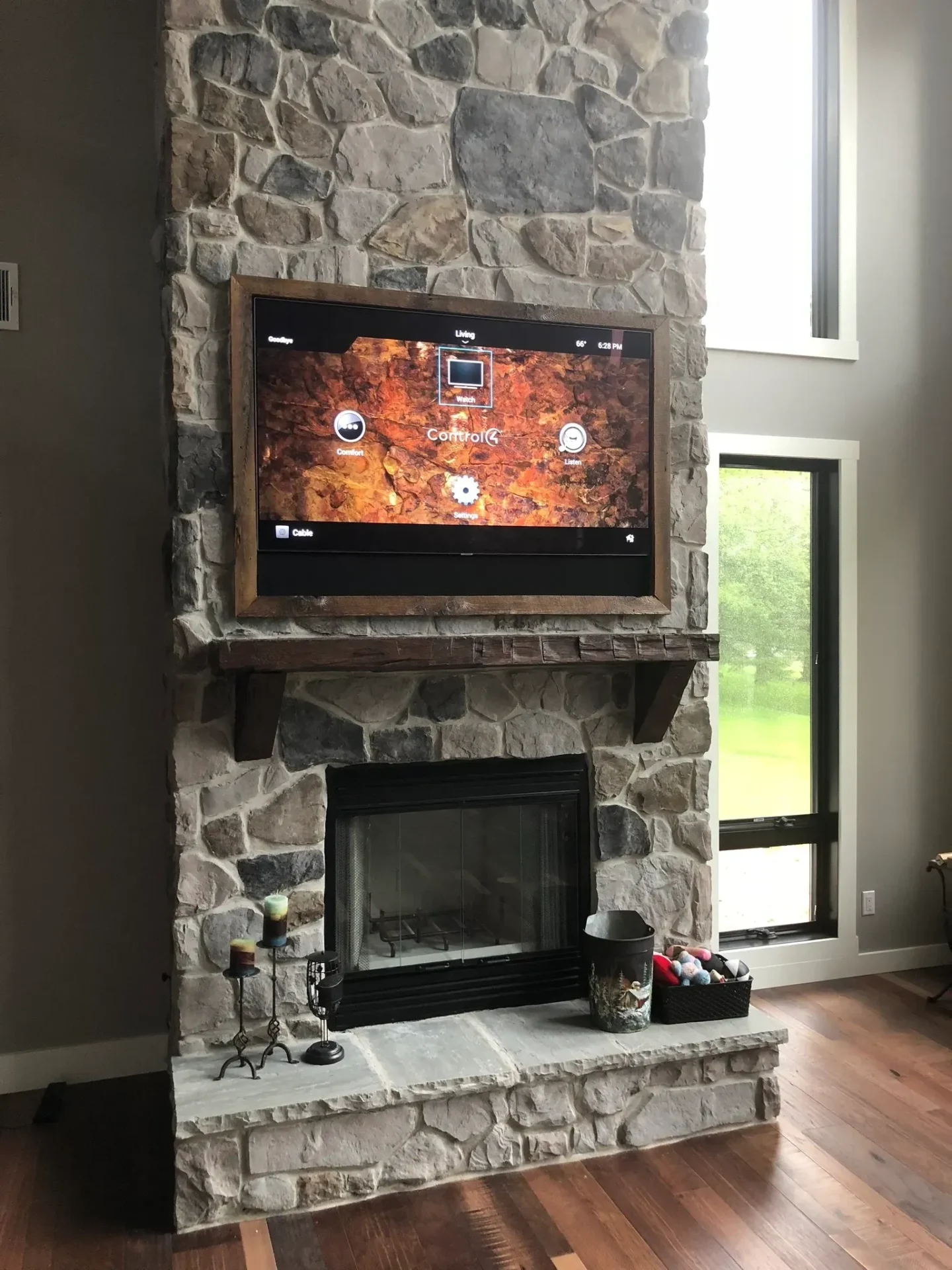 Stone fireplace with mounted television above.