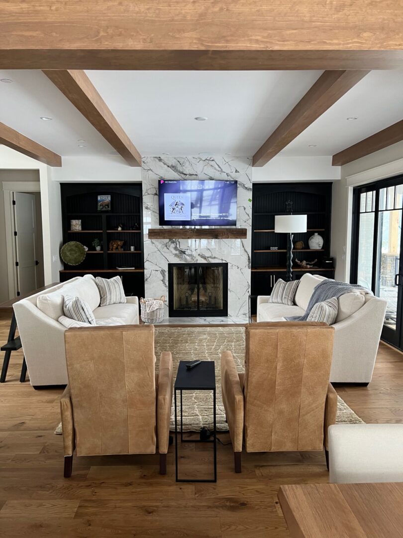 Cozy living room with neutral tones and a central fireplace.