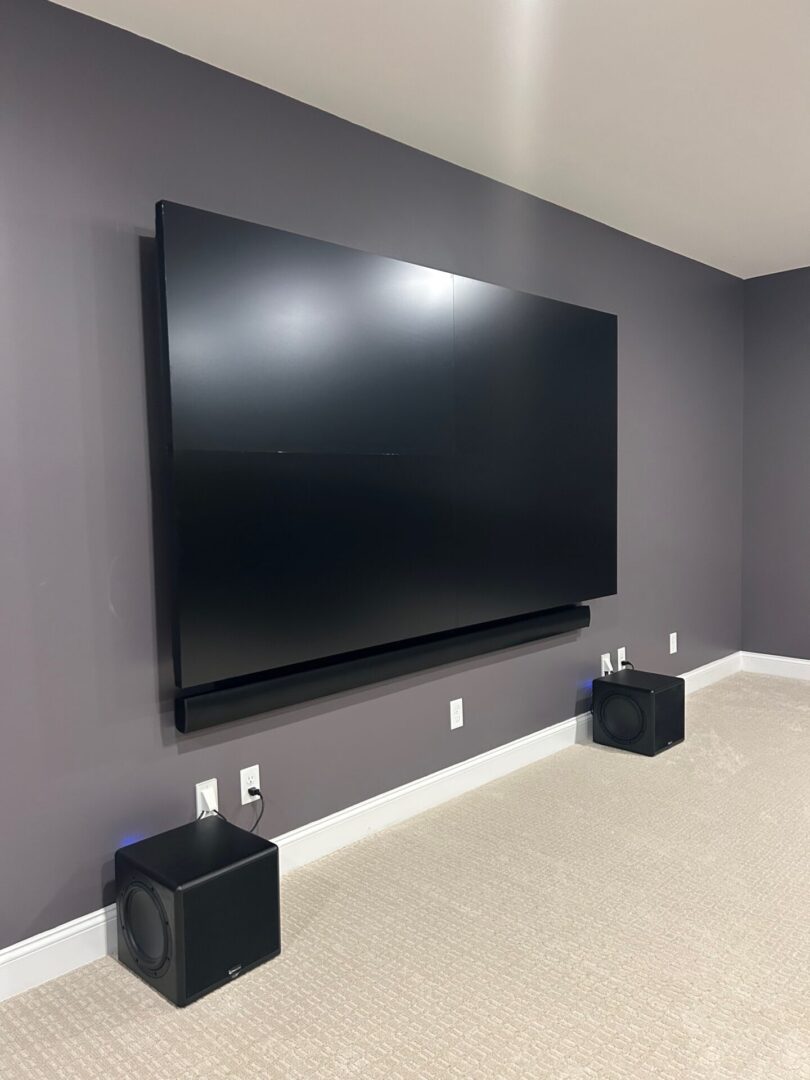 Modern living room with wall-mounted TV and soundbar.