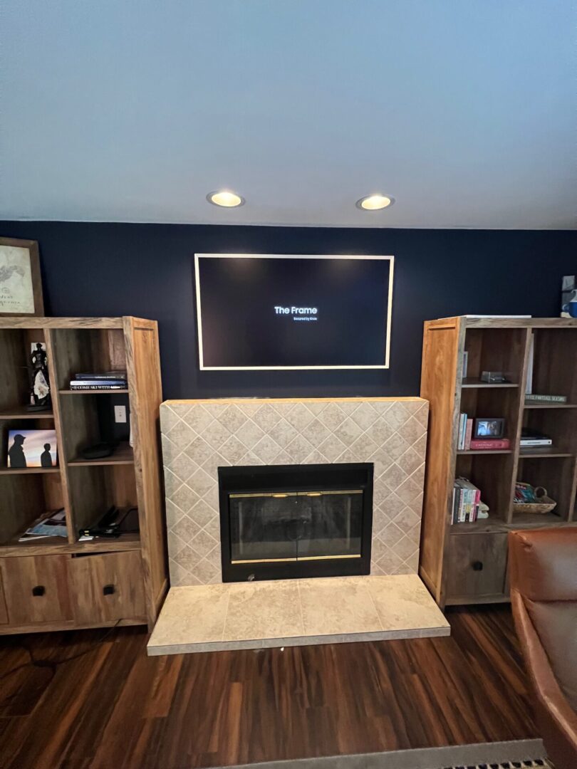 Cozy living room with a fireplace and wooden shelves.